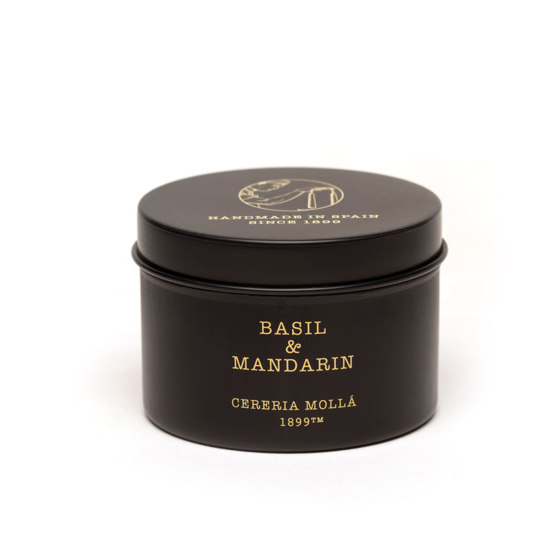 Bougie de voyage parfumée au basilic et à la mandarine dans un récipient en verre noir